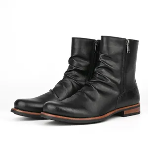 Detailed view of black wrinkled leather men's boots featuring dual side zipper closure