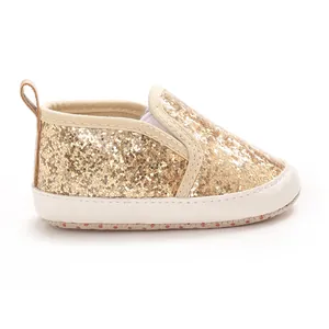 Side view of gold glitter baby pre-walker shoe with soft cream PU sole and heel pull tab