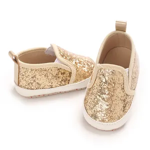 Close-up view of sparkling gold glitter baby shoes with soft PU soles for 0-1 year infants