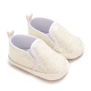 Detail view of sparkly cream baby walking shoes with soft PU soles