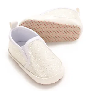 Detailed view of white glitter baby soft sole shoes with non-slip dot sole design