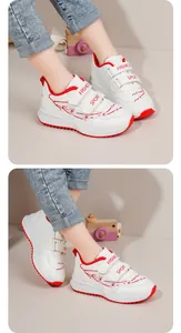 Dettaglio delle sneakers bianche da bambina con ricami floreali rosa e chiusura a strappo.