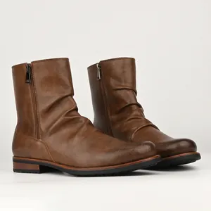 Detail shot of brown casual men's boots featuring pleated leather and dual side zippers