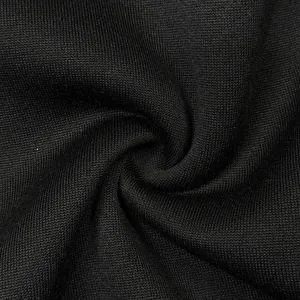 Detailed macro shot of premium black knitted fleece fabric texture for men's winter hoodie