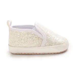 Side view of white glitter baby shoes with soft PU soles for infant pre-walking.