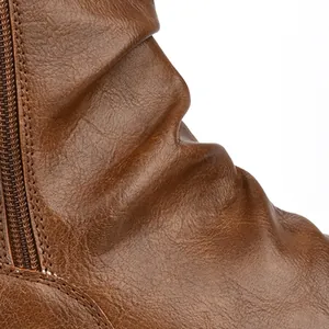 Macro view of textured brown wrinkled leather and side zipper detail on men's boots