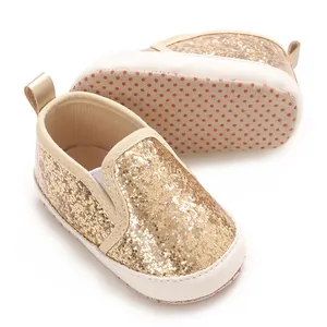Detailed close-up view of gold glitter baby soft sole pre-walker shoes with white trim