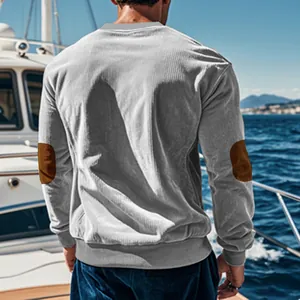 Back view of men's grey corduroy long sleeve shirt with brown elbow patches on a boat