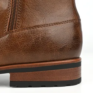 Close-up of brown leather men's boot heel with durable rubber sole and stitching.