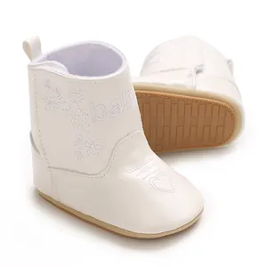 Detail view of white faux leather baby winter boots with heart embroidery and soft sole