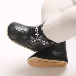 Detailed view of black baby cotton shoes with elegant heart and flower embroidery