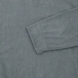 Close-up detail of grey corduroy texture on men's long sleeve sweatshirt cuff