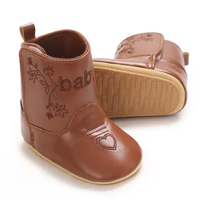 Brown baby boots with 'baby' embroidery and floral patterns, showing side and sole views.