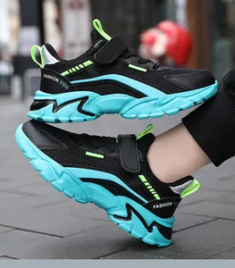 Close-up of breathable mesh children's sneakers in black with teal and neon green accents.