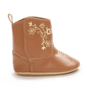 Detailed side view of brown British style baby leisure boots with gold floral embroidery