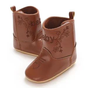 Detail view of brown faux leather baby winter boots featuring floral embroidery and a heart