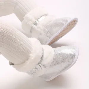 Detail showing silver glitter fabric and white faux fur trim on baby walking shoes