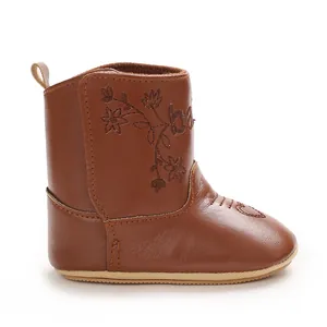 Detailed side view of brown faux leather winter baby boots with delicate flower embroidery