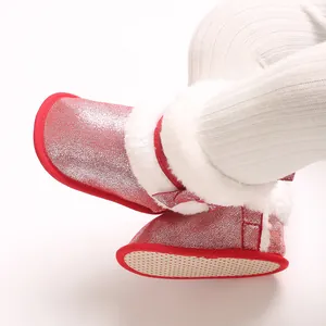 Close-up detail of stylish red glitter baby walking boots with soft white faux fur