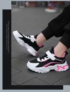 Close-up of girls' black and pink breathable mesh sneakers with velcro strap