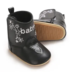 Detailed view of black British style casual baby winter boots with white heart embroidery