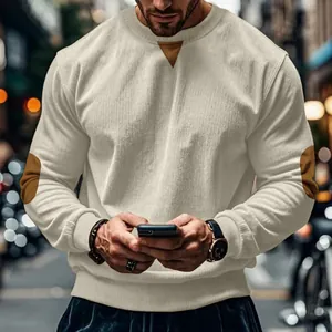 Detail of men's corduroy sweatshirt featuring brown elbow patches and neck detail.