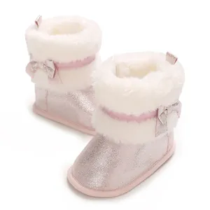 Pink glittery baby boots featuring soft faux fur trim and a charming decorative bow