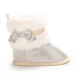 Side view of silver baby girl winter boot with white fur trim and silver bow