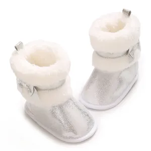 Detail of silver sparkly baby boots with soft white faux fur lining and bow ornament