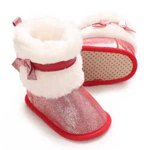 Detail view of red glitter baby winter boots with white fur trim and soft non-slip sole