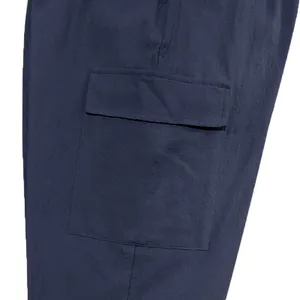Detailed view of the large side flap pocket on navy blue linen blend cargo pants