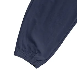 Detail view of the elasticated leg cuff on navy blue men's cotton linen cargo pants