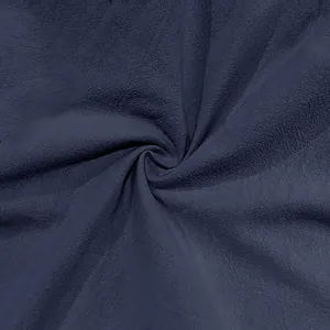 Detailed macro shot of navy blue cotton linen fabric texture for summer cargo pants