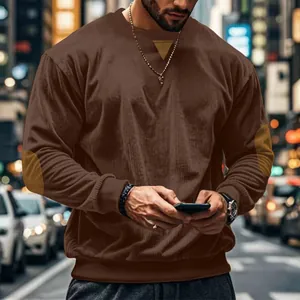Close-up detail of brown corduroy long sleeve T-shirt showing rib texture and casual fit