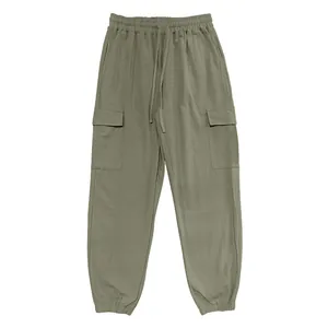 Detail view of olive green cotton linen cargo pants with drawstring waist joggers.