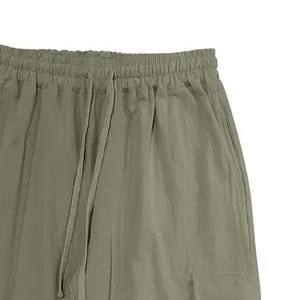 Close-up of men's cotton linen cargo pants featuring drawstring waist and pockets