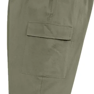 Close-up of large side cargo pocket with flap on olive green men's pants.