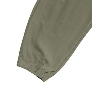 Detail of the elasticated ankle cuff on men's lightweight cotton linen cargo pants.