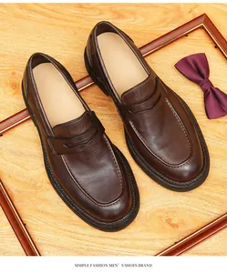 Handmade dark brown leather loafers with Goodyear welted soles and penny strap detail.