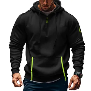 Men's black half-zip hoodie with neon green details and arm pocket, athletic fit.