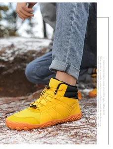 Detailed view of yellow winter snow boots featuring a warm fur lining and non-slip rubber sole