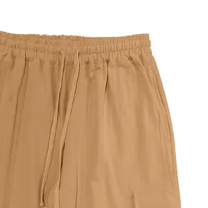 Detail of the elastic waistband and drawstring on men's khaki cotton linen cargo pants