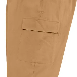 Detailed macro view showing a large flap cargo pocket on brown cotton linen men's pants