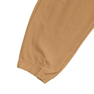 Detailed view of the elasticized ankle cuff on men's khaki cotton linen cargo pants.