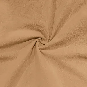 Detailed macro view of breathable cotton linen fabric texture in earthy brown tone