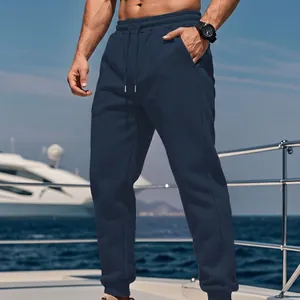 Detailed view of navy blue fleece-lined casual joggers for men in an outdoor setting