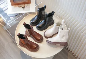 Detailed close-up of stylish children's Martin boots in black, brown and white colors