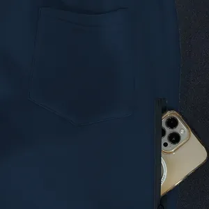 Close-up detail of men's navy fleece sweatpants showing back pocket and secure zipper side pocket.