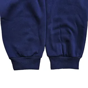 Detailed close-up view of navy blue ribbed ankle cuffs on men's casual fleece sweatpants.