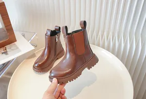 Close-up of children's brown British style retro Chelsea boots with side zipper